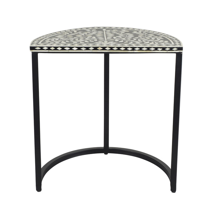 The Bone Inlay Half Moon Side Table Black with Black Frame 44cm is a half-moon shaped black metal side table with a black and white design, featuring intricate geometric patterns that evoke the artistic elegance of bone inlay.