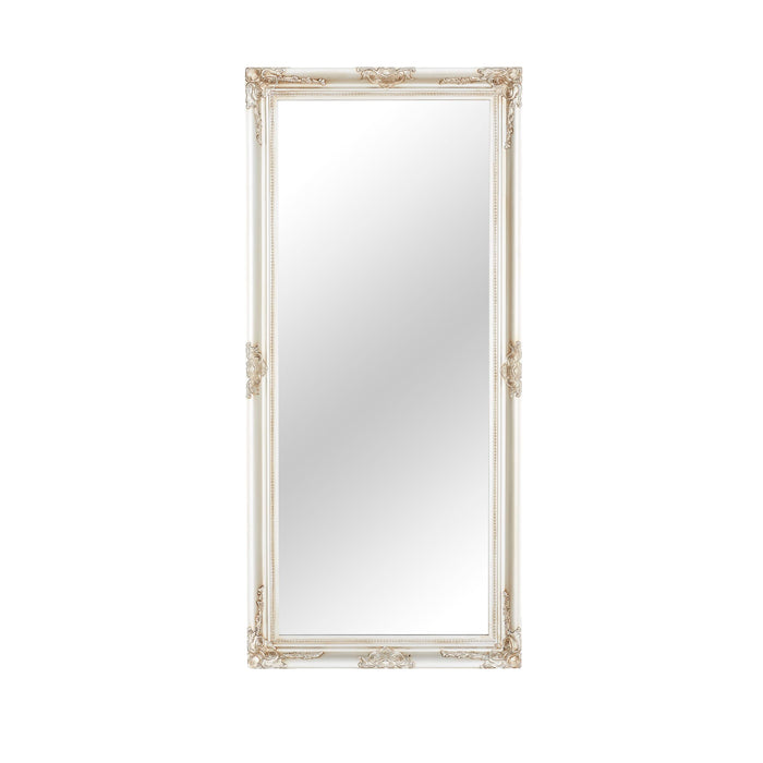 The Jane Mirror Champagne Silver 167x77cm features a tall rectangular shape with an ornate frame adorned with intricate carvings at the corners and edges, showcasing a versatile design. This elegant mirror seamlessly complements any decor setting, exuding a timeless charm.