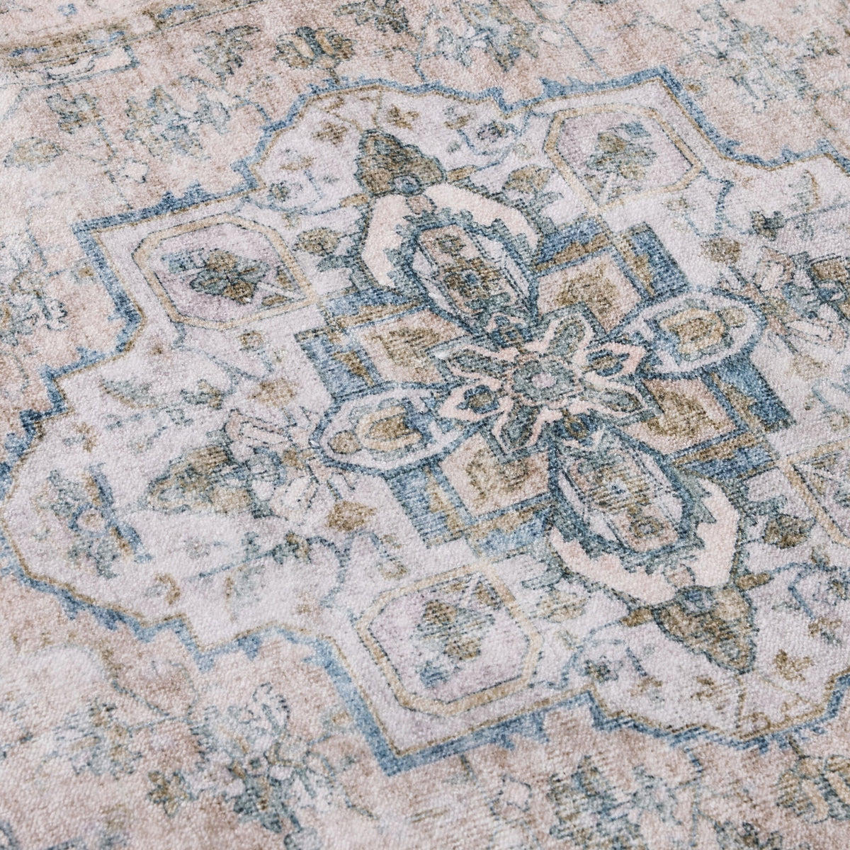 The Manisa Washable Runner 80x200cm features a faded Persian-style design with intricate geometric and floral patterns in muted blue, beige, and green tones, and has a 7mm pile height.