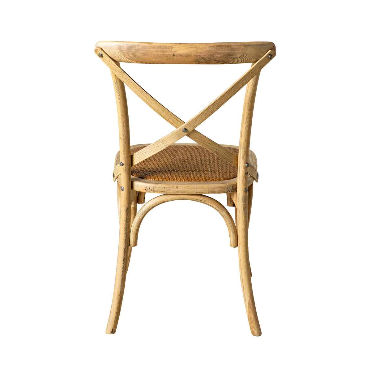 The Provincial Cross Back Dining Chair Natural Oak, featuring a curved X-shaped backrest and woven seat, is photographed from the back against a white background, highlighting its French Provincial design elegance.