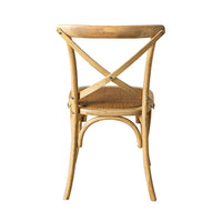 The Provincial Cross Back Dining Chair Natural Oak, featuring a curved X-shaped backrest and woven seat, is photographed from the back against a white background, highlighting its French Provincial design elegance.