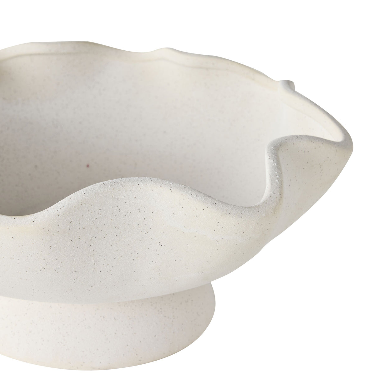 The Tranquil Wavy Pedestal Bowl features a wide, wavy rim and a white sand clay finish, elegantly displayed on a pedestal base to create a stunning decorative centrepiece against a white background.