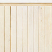 A close-up of a wooden panel with vertical grooves reveals a light, natural texture, reminiscent of the whitewashed mango wood finish of the Deva 2 Door Buffet 114 x 80 x 43cm, highlighting its refined elegance and subtle charm.