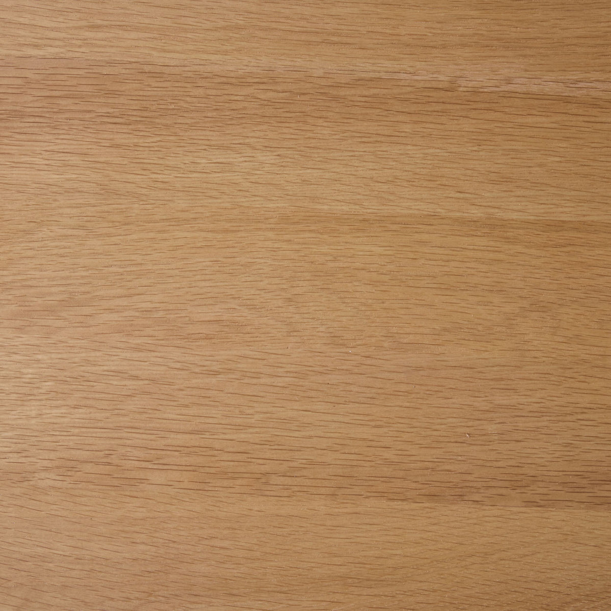 Close-up view of a light brown wooden surface with visible grain patterns and a smooth finish, similar to the craftsmanship of the Spintara 4 Drawer Chest Light Oak.