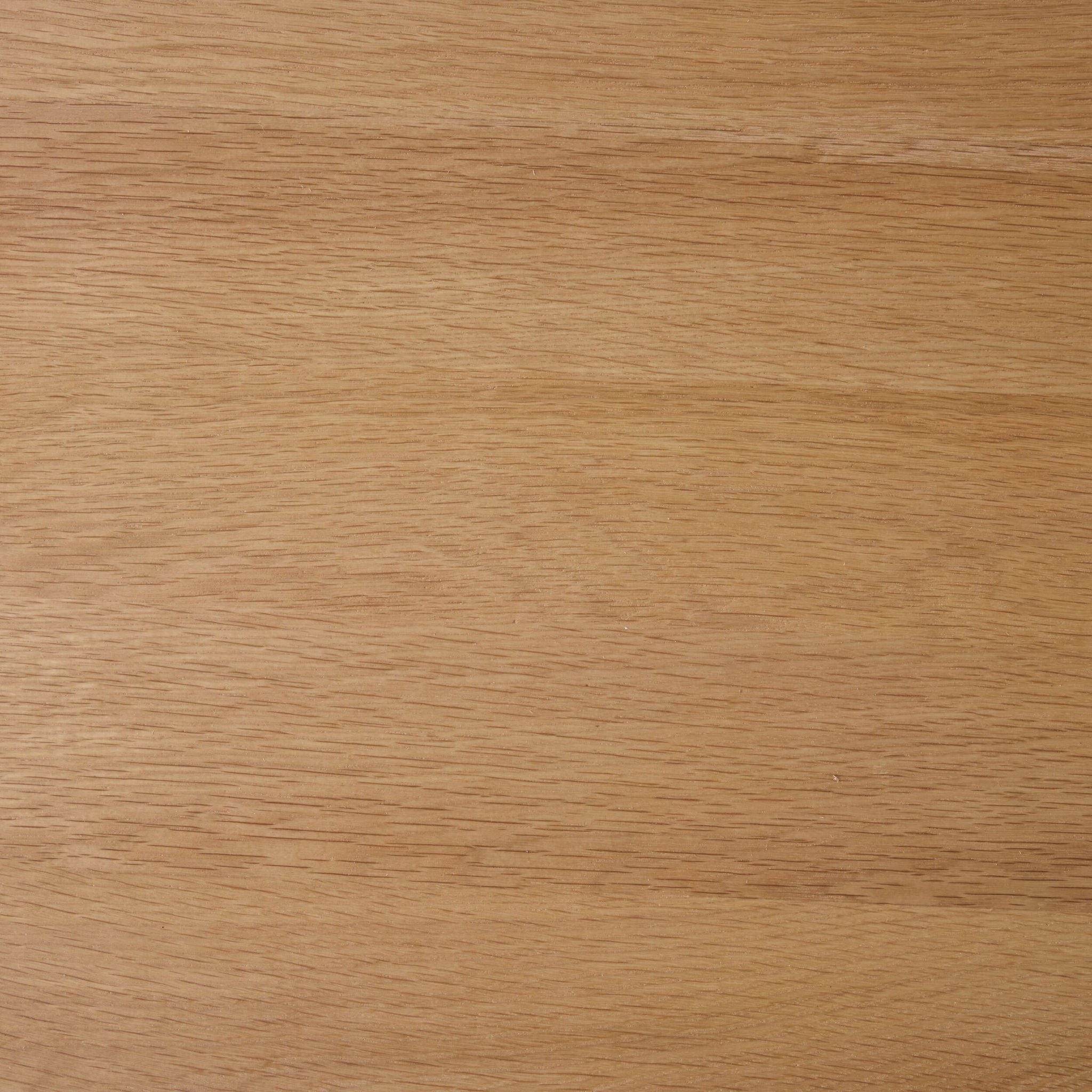 Close-up view of a light brown wooden surface with visible grain patterns and a smooth finish, similar to the craftsmanship of the Spintara 4 Drawer Chest Light Oak.